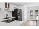 Updated kitchen showcasing stainless steel appliances and view to the pool at 621 85Th N Ave, St Petersburg, FL 33702