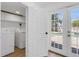 Functional laundry room with washer, dryer, built-in cabinets, and access to pool area at 621 85Th N Ave, St Petersburg, FL 33702