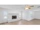 Bright living room with stone fireplace, ceiling fan, neutral paint, and laminate flooring at 621 85Th N Ave, St Petersburg, FL 33702