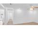 Bright, open living room with neutral paint, ceiling fan, and easy access to other rooms at 621 85Th N Ave, St Petersburg, FL 33702