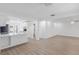 Spacious open living area with laminate floors, neutral paint, and partial view of kitchen at 621 85Th N Ave, St Petersburg, FL 33702