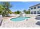 Private backyard pool and spa feature brick paver surround, fenced perimeter, and pool house at 621 85Th N Ave, St Petersburg, FL 33702
