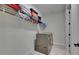 Well-lit laundry room with a modern washer and dryer, clean white walls, and convenient storage shelves at 6252 Hidden Branch Dr, Apollo Beach, FL 33572