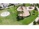 Aerial view of a playground with modern equipment and shaded seating, perfect for Gathering fun within the community at 6252 Hidden Branch Dr, Apollo Beach, FL 33572