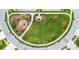 Aerial view of a community park featuring a modern playground, green spaces, and walking paths for residents to enjoy at 6252 Hidden Branch Dr, Apollo Beach, FL 33572