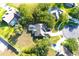 Aerial view of the home, showcasing the backyard with a screened-in pool and lush landscaping at 63 Forest Wood Ct, Spring Hill, FL 34609