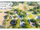 Aerial view of community with mature trees, circular streets, and neighborhood swimming pools at 63 Forest Wood Ct, Spring Hill, FL 34609