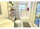 Bathroom featuring a tub with shower curtain, sink, toilet, and decorative stained-glass window at 63 Forest Wood Ct, Spring Hill, FL 34609