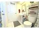 Bathroom featuring a pedestal sink, toilet, metal storage rack, and patterned floor mat at 63 Forest Wood Ct, Spring Hill, FL 34609