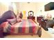 Spacious bedroom featuring dark wood furniture, a striped bedspread, and a wall-mounted television at 63 Forest Wood Ct, Spring Hill, FL 34609