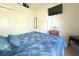 This cozy bedroom has ample storage with a large closet and features a mounted television at 63 Forest Wood Ct, Spring Hill, FL 34609