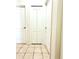 Hallway with neutral tile floor with several white doors and trim at 63 Forest Wood Ct, Spring Hill, FL 34609