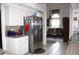 Spacious kitchen featuring stainless steel refrigerator, white cabinets, open to living area at 63 Forest Wood Ct, Spring Hill, FL 34609