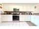Well-lit kitchen with stainless steel oven, white cabinets, and neutral countertops at 63 Forest Wood Ct, Spring Hill, FL 34609