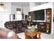 Spacious living room with a large entertainment center and comfortable seating arrangement at 63 Forest Wood Ct, Spring Hill, FL 34609