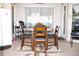 Covered patio dining area with plenty of seating and adjacent to refrigerator at 63 Forest Wood Ct, Spring Hill, FL 34609