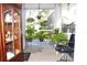Enclosed patio with plants and comfortable seating overlooks the beautiful garden and pool at 63 Forest Wood Ct, Spring Hill, FL 34609