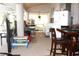 Spacious outdoor patio with dining area, refrigerator, and view of the landscaped backyard at 63 Forest Wood Ct, Spring Hill, FL 34609