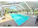 A luxurious screened-in pool and lounge chairs offers the perfect spot for outdoor relaxation at 63 Forest Wood Ct, Spring Hill, FL 34609