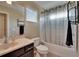 Bathroom with vanity, toilet, and tub with shower and patterned shower curtain at 6918 Frog Pocket Pl, Tampa, FL 33616