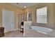 Bright bathroom with soaking tub, glass shower, and neutral tiling at 6918 Frog Pocket Pl, Tampa, FL 33616
