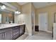 Bathroom with double sinks, granite countertops and dark wood cabinets at 6918 Frog Pocket Pl, Tampa, FL 33616