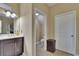 Bathroom vanity adjacent to toilet room and linen storage closet at 6918 Frog Pocket Pl, Tampa, FL 33616