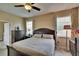 Neutral colored bedroom with large dresser, ceiling fan, and natural light at 6918 Frog Pocket Pl, Tampa, FL 33616