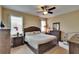 Bedroom with dark wooden furniture, ceiling fan, and natural light at 6918 Frog Pocket Pl, Tampa, FL 33616