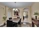 Open dining space with hardwood floors, views to the kitchen and back patio, and neutral paint at 6918 Frog Pocket Pl, Tampa, FL 33616