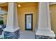 Close-up of the front door with decorative pillars and stone accents at 6918 Frog Pocket Pl, Tampa, FL 33616