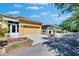 Townhome exterior with a two car garage, covered entry and neat landscaping at 6918 Frog Pocket Pl, Tampa, FL 33616