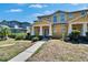 Well-maintained townhome with lush landscaping and covered entrance at 6918 Frog Pocket Pl, Tampa, FL 33616