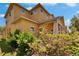 Two-story townhome with colorful landscaping and a clean exterior at 6918 Frog Pocket Pl, Tampa, FL 33616