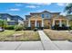 Inviting two-story townhome with manicured lawn and covered front porch at 6918 Frog Pocket Pl, Tampa, FL 33616