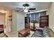 Living room featuring black leather furniture, a ceiling fan, and shelving at 6918 Frog Pocket Pl, Tampa, FL 33616
