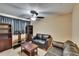 Cozy living room features comfortable seating, ceiling fan, and media center at 6918 Frog Pocket Pl, Tampa, FL 33616