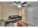 Living room featuring black leather furniture and a ceiling fan at 6918 Frog Pocket Pl, Tampa, FL 33616