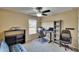Well-lit office space with a fan, desk, shelves, and comfortable seating at 6918 Frog Pocket Pl, Tampa, FL 33616
