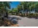 Gated community entrance with stone walls and mature trees at 6918 Frog Pocket Pl, Tampa, FL 33616