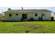 Exterior view of the backyard showcasing a well-maintained lawn and patio at 7229 Northbridge Blvd, Tampa, FL 33615