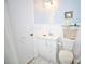 Bathroom with a white vanity, standard toilet, framed art and a tiled floor at 7229 Northbridge Blvd, Tampa, FL 33615