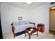 Bright bedroom features a daybed with patterned cushions, side table and neutral walls and carpet at 7229 Northbridge Blvd, Tampa, FL 33615
