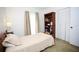 Bright bedroom with a cozy bed, built in bookshelf, neutral walls and carpeting at 7229 Northbridge Blvd, Tampa, FL 33615