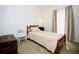 Comfortable bedroom with a cozy bed, side table, neutral walls and carpeting at 7229 Northbridge Blvd, Tampa, FL 33615