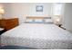 Comfortable bedroom featuring a cozy bed with patterned comforter and natural light, complemented by light-colored walls at 7229 Northbridge Blvd, Tampa, FL 33615