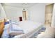 Bright bedroom features a large bed with patterned comforter, complemented by neutral-toned walls and carpet at 7229 Northbridge Blvd, Tampa, FL 33615