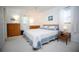 Bright bedroom features neutral carpet, white walls, and a cozy bed with patterned blue bedding at 7229 Northbridge Blvd, Tampa, FL 33615
