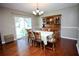 This dining room features hardwood floors, a table with six chairs, and a glass door to the outside at 7229 Northbridge Blvd, Tampa, FL 33615