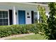 Up close shot of the white brick home's door with black accents and manicured bushes in front at 7229 Northbridge Blvd, Tampa, FL 33615